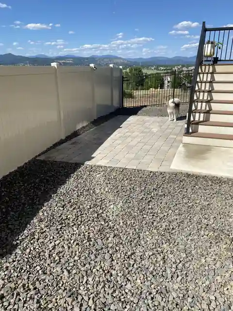 Side-yard paver walk bordered by gravel