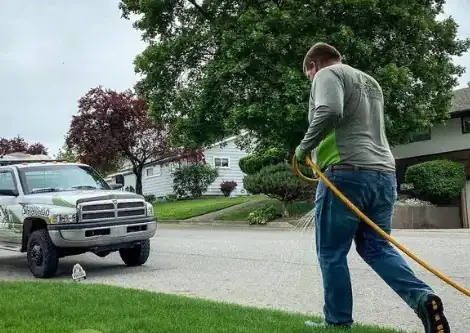 A fertilization hose pulled from a lettered company truck